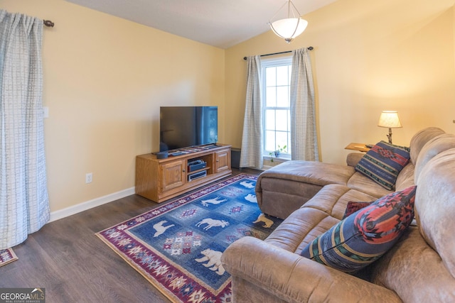 living area with vaulted ceiling, dark wood finished floors, and baseboards