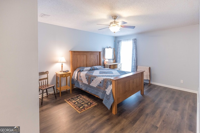 bedroom with baseboards, visible vents, ceiling fan, dark wood-style flooring, and a textured ceiling