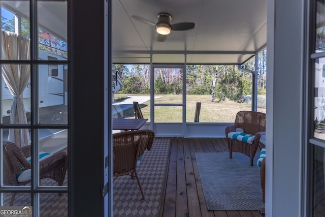 sunroom / solarium with plenty of natural light and a ceiling fan