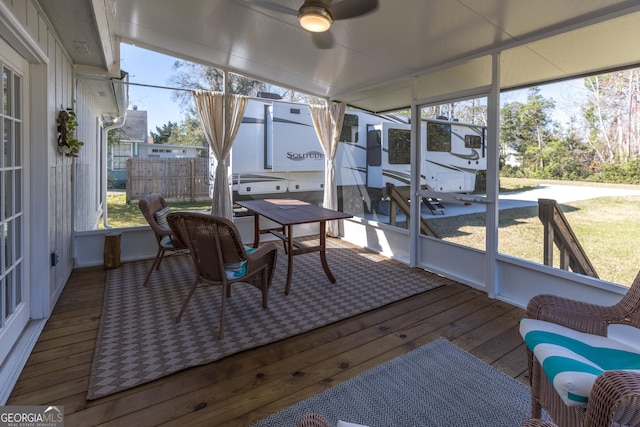 sunroom / solarium with ceiling fan and lofted ceiling