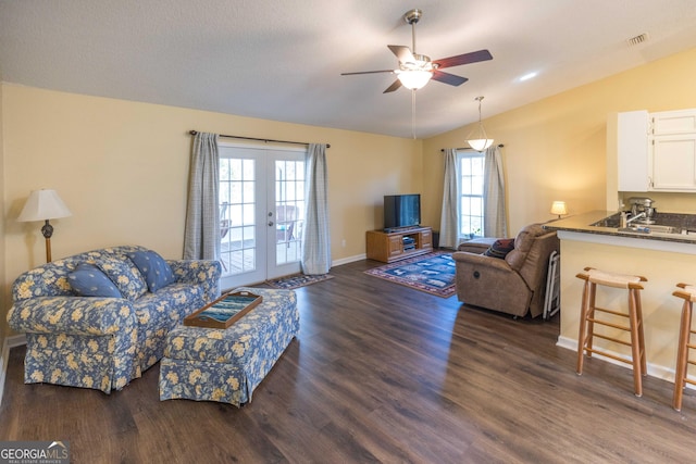 living room featuring lofted ceiling, visible vents, dark wood-style flooring, and french doors