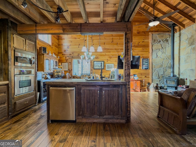 kitchen featuring stainless steel appliances, a wood stove, wooden ceiling, and dark wood-style floors