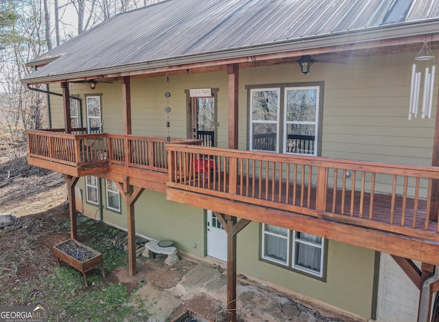 rear view of house featuring metal roof