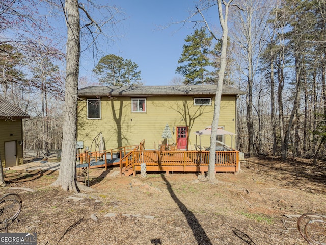 rear view of house featuring a deck