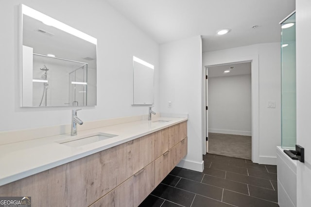 bathroom featuring double vanity, a stall shower, tile patterned flooring, and a sink