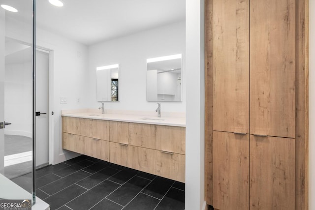 full bathroom featuring double vanity, a sink, and tile patterned floors