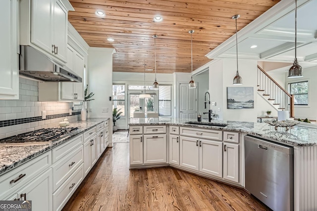 kitchen featuring dark wood finished floors, wood ceiling, decorative light fixtures, stainless steel appliances, and a sink