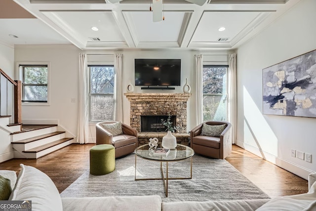 living room featuring a fireplace, stairway, wood finished floors, coffered ceiling, and baseboards