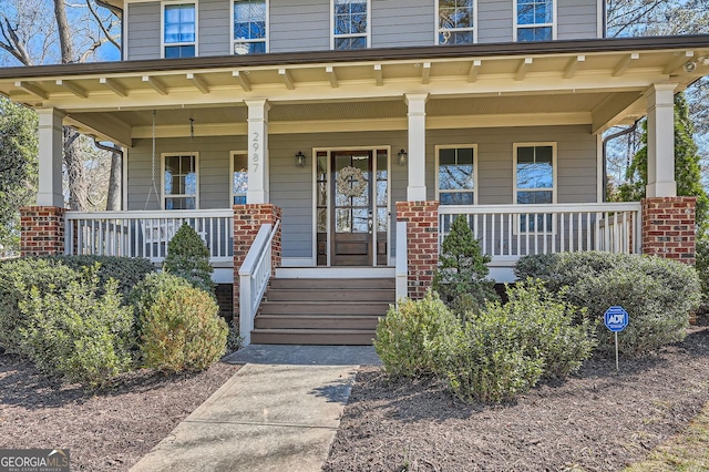 view of exterior entry featuring a porch