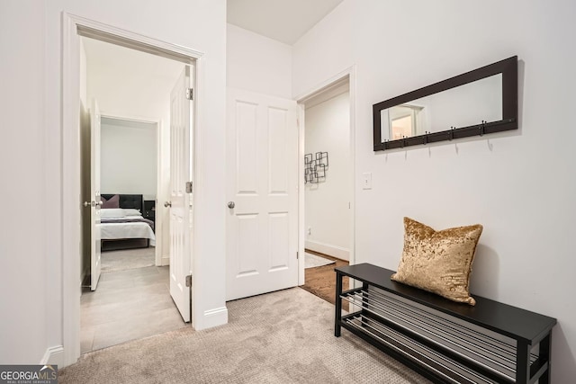 hallway with light colored carpet