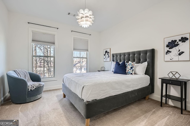 bedroom featuring carpet floors, visible vents, and baseboards