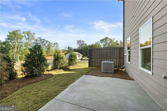 view of patio / terrace with central air condition unit and fence