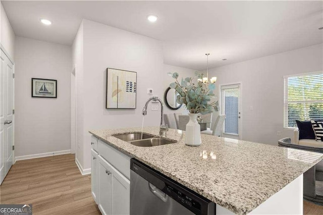 kitchen featuring light wood-style flooring, a sink, white cabinetry, dishwasher, and an inviting chandelier