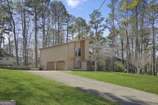 view of property exterior featuring an attached garage, a lawn, and driveway