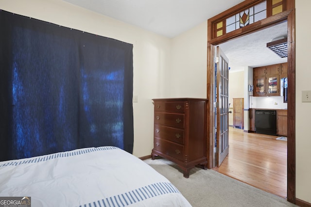 bedroom featuring carpet flooring, a dry bar, a textured ceiling, and baseboards