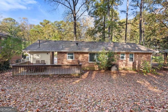 back of property with a deck and brick siding