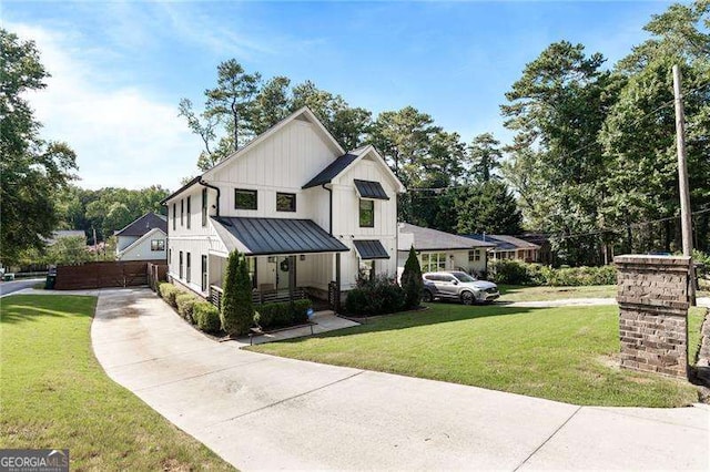 modern farmhouse style home featuring board and batten siding, a standing seam roof, metal roof, and a front lawn