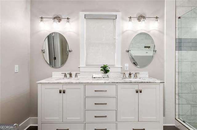 full bathroom with double vanity, a tile shower, and a sink