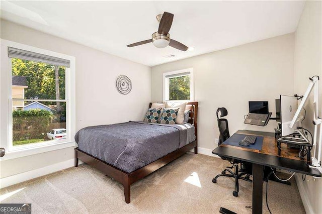 bedroom with a ceiling fan and baseboards