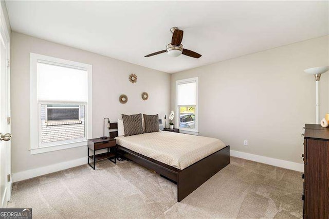 carpeted bedroom with baseboards and a ceiling fan