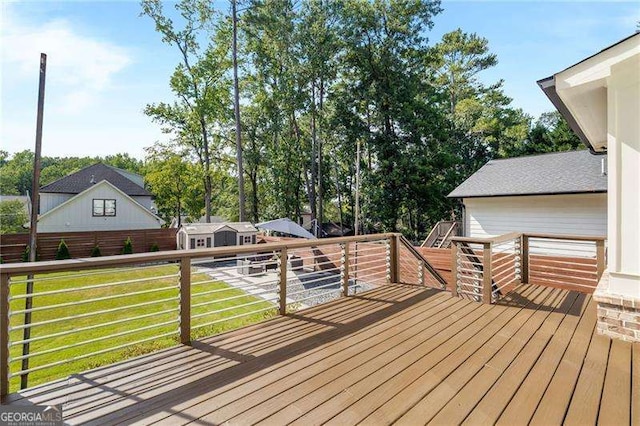 deck with an outbuilding and a yard