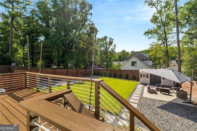 deck featuring a fenced backyard, an outdoor hangout area, and a lawn