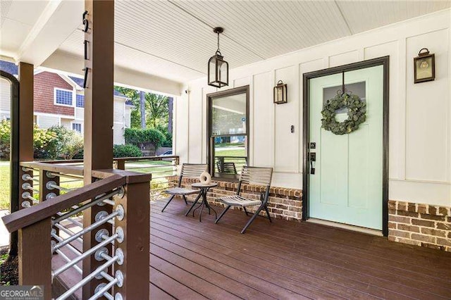 wooden terrace featuring covered porch