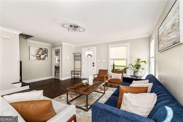 living room with ornamental molding, baseboards, and wood finished floors