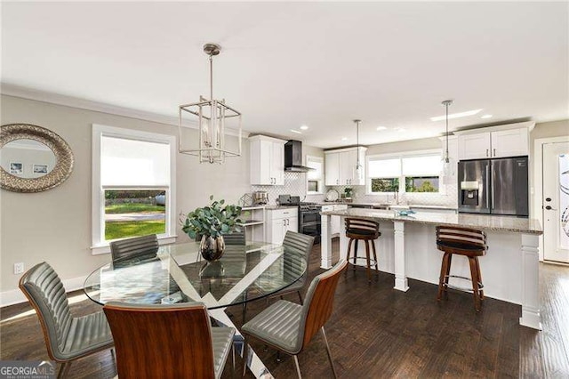 dining area featuring an inviting chandelier, baseboards, dark wood-type flooring, and recessed lighting