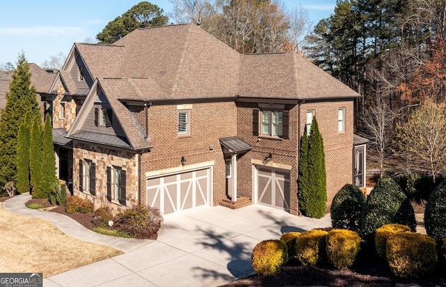 5230 Harris Springs Dr, Cumming, GA 30040 - view of front of home featuring concrete driveway, an attached garage, a shingled roof, and a standing seam roof