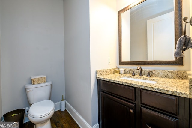 5230 Harris Springs Dr, Cumming, GA 30040 - bathroom with toilet, vanity, baseboards, and wood finished floors