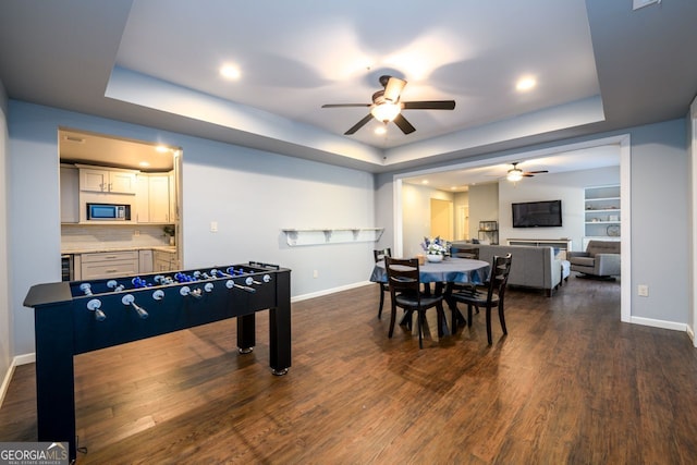5230 Harris Springs Dr, Cumming, GA 30040 - recreation room featuring a ceiling fan, a tray ceiling, baseboards, dark wood-style floors, and recessed lighting