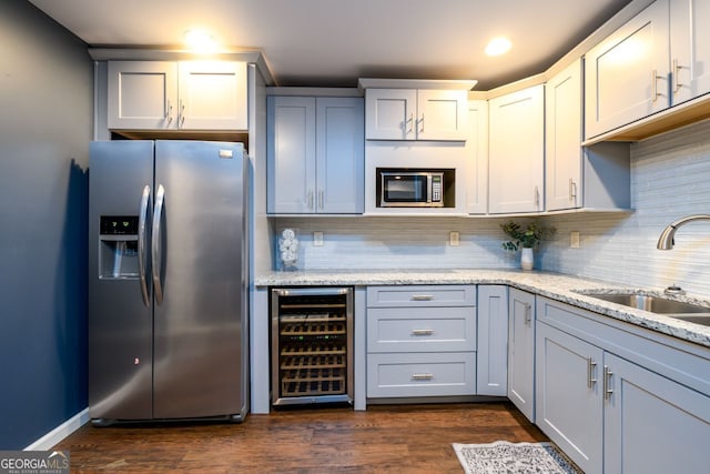 5230 Harris Springs Dr, Cumming, GA 30040 - kitchen with stainless steel appliances, wine cooler, a sink, tasteful backsplash, and light stone countertops