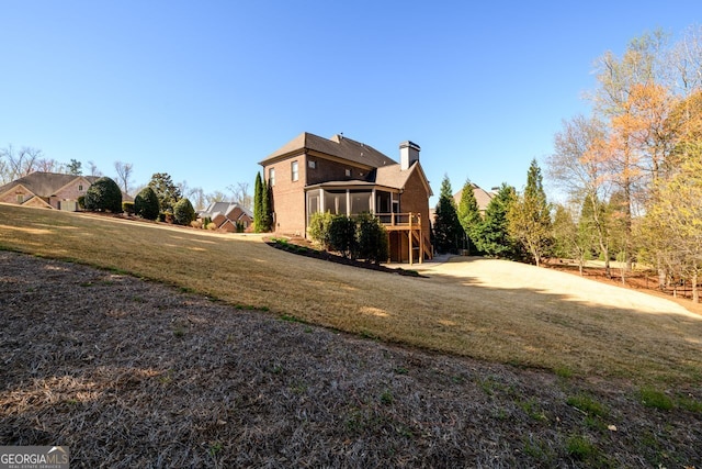 5230 Harris Springs Dr, Cumming, GA 30040 - rear view of house featuring a sunroom, a chimney, and a yard
