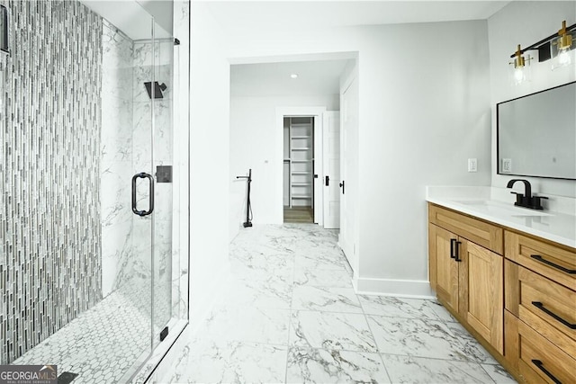 full bath with marble finish floor, baseboards, vanity, and a marble finish shower