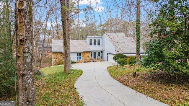 2590 Runic Way, Johns Creek, GA 30022 - mid-century inspired home featuring concrete driveway, stone siding, and an attached garage
