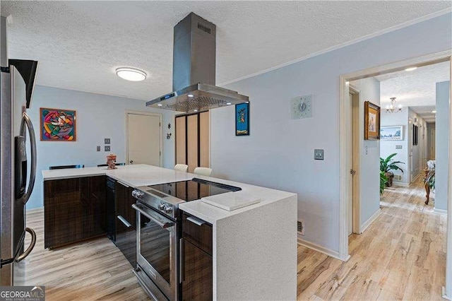 kitchen with stainless steel appliances, light wood finished floors, island exhaust hood, and light countertops