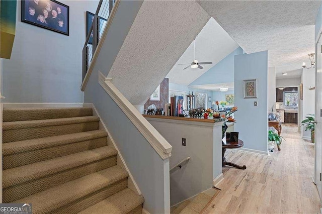 2590 Runic Way, Johns Creek, GA 30022 - staircase with wood finished floors, a ceiling fan, a textured ceiling, and vaulted ceiling