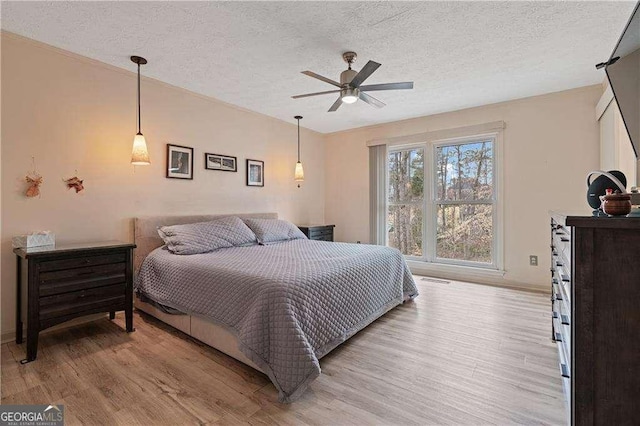 2590 Runic Way, Johns Creek, GA 30022 - bedroom featuring light wood finished floors, a textured ceiling, and a ceiling fan