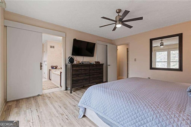 2590 Runic Way, Johns Creek, GA 30022 - bedroom with light wood-style flooring, a textured ceiling, a ceiling fan, and connected bathroom