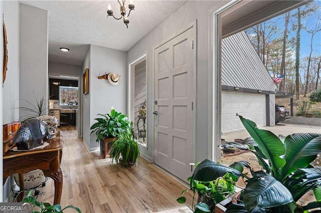2590 Runic Way, Johns Creek, GA 30022 - foyer with wood finished floors, a chandelier, and a textured ceiling