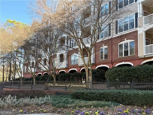 view of building exterior with fence