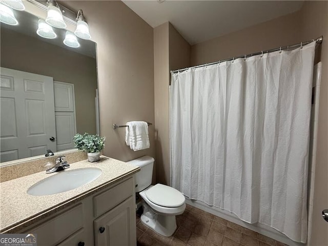 bathroom with toilet and vanity