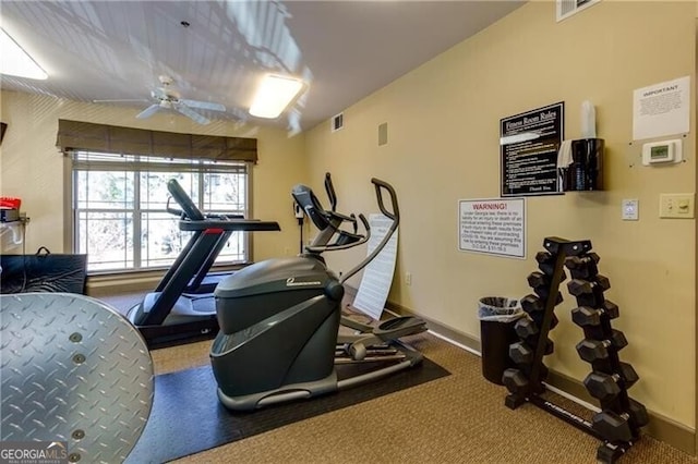 exercise area featuring ceiling fan, visible vents, and baseboards