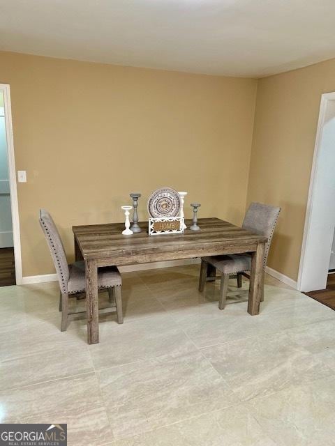 dining room featuring baseboards