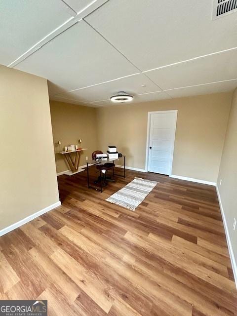 interior space featuring visible vents, baseboards, and wood finished floors