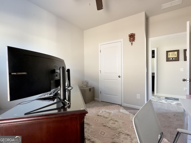 office space with carpet flooring, ceiling fan, and baseboards