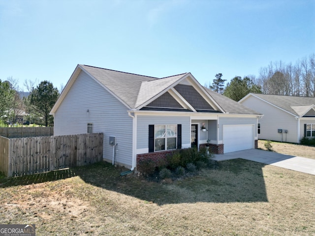 view of front facade with brick siding, concrete driveway, an attached garage, fence, and a front lawn