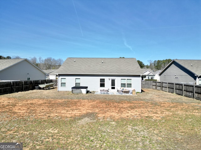 rear view of house featuring a yard, a patio, and a fenced backyard