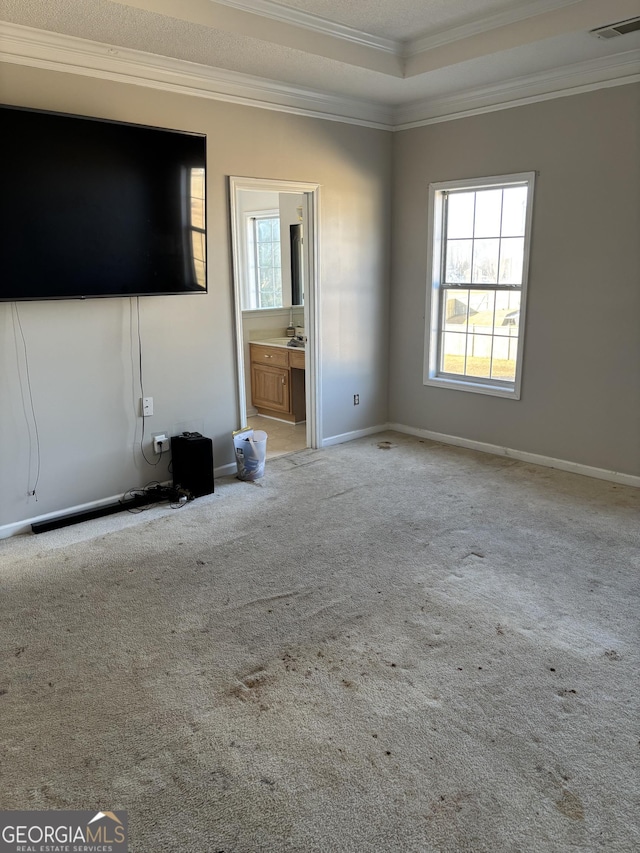 unfurnished living room featuring baseboards, visible vents, carpet flooring, and ornamental molding